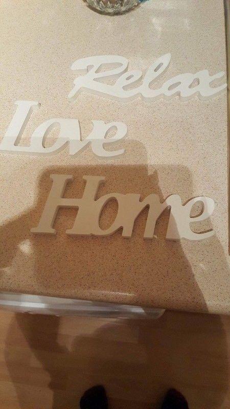 White wooden home, love and relax signs