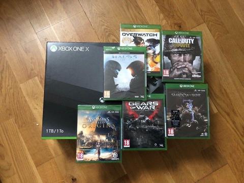 Brand new unopened Xbox One X with 6 games