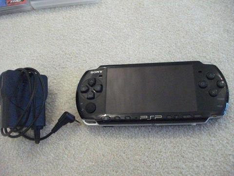 Sony PSP with charger, 5 films and 8 games