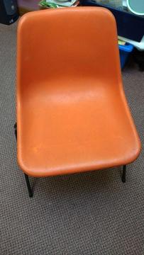 Free - 12 chairs, orange plastic. Buyer uplifts