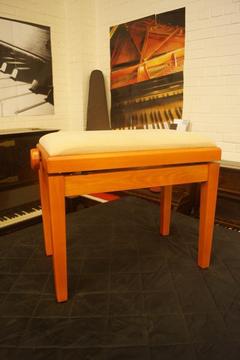 New piano stool. Adjustable in cherry wood. Can be shipped