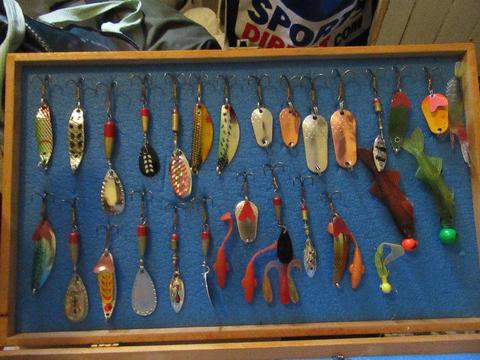 Various fishing lures in wooden box