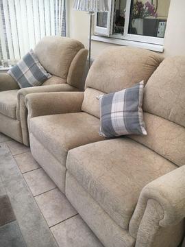 Four piece cream material sofa including recliner chair