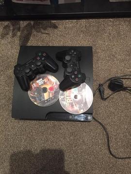 PS3 game console with two controllers