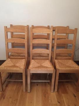 6 Lovely elegant solid wood chairs with rafia seats, very strong