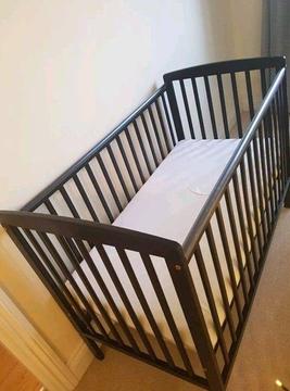 Black wooden baby cot and mattress