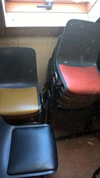 Approx 44 Solid plastic chairs, some multi coloured, 5 with small desk attached, collection only
