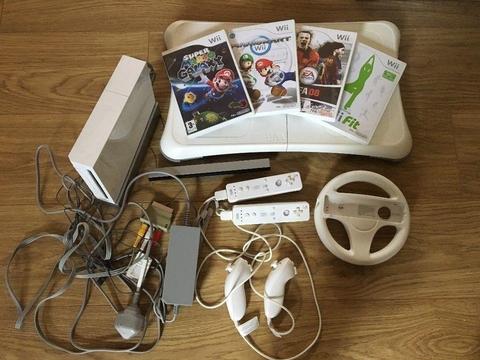 Nintendo Wii (with 2 controllers + 1 steering wheel + 1 Wii Fit board + 4 games)