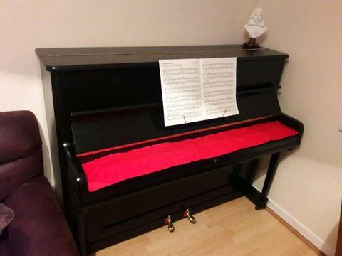 Black overstrung upright piano