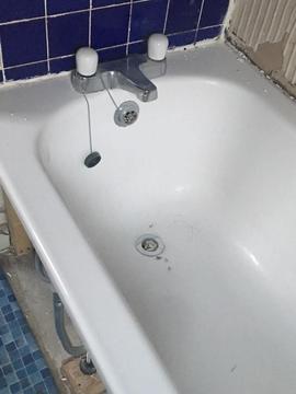 Standard white bath tub with mixer tap as seen in picture