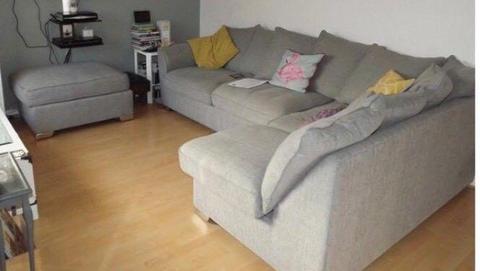 Grey fabric corner sofa and pouffee