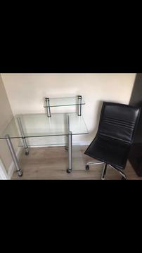 Glass office desk with black chair