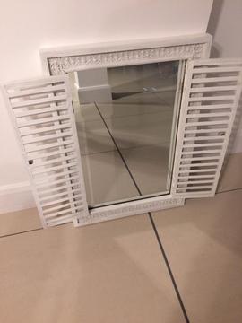 White wooden mirror with moveable shutters