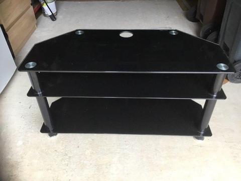 Black glass TV stand with two black glass shelves below