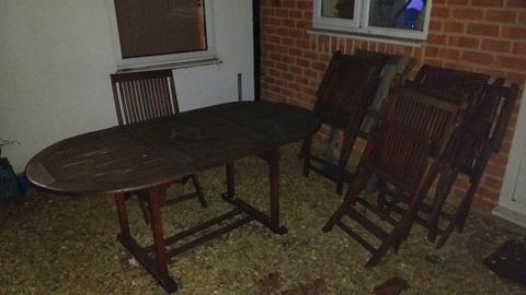 Wooden outside table with 7 chairs needs a little TLC