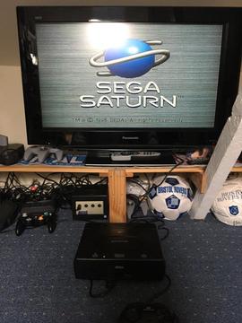 Sega Saturn console with games