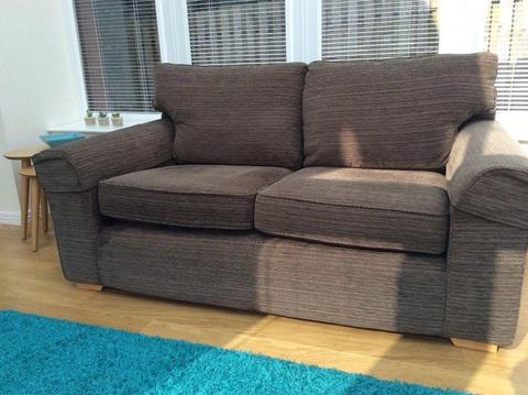 Light brown material sofa with protective armrests. Medium 2 seater